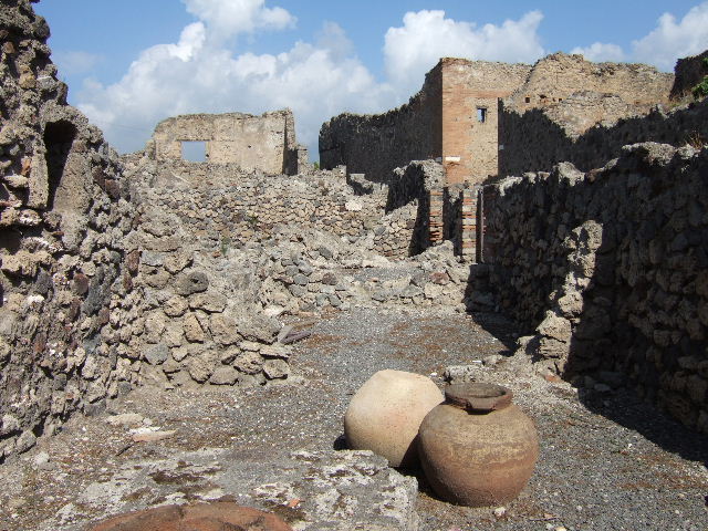 VII.16.7 Pompeii. September 2019. Looking north from area of rear room, towards doorways of VII.16.8/9 and 10 on Vicolo del Gigante.
Photo courtesy of Klaus Heese.
