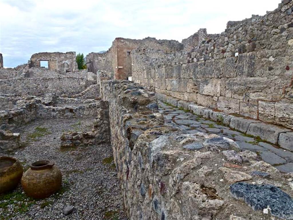 VII.16.7 Pompeii. September 2011. Looking north along east wall of bar-room, and Vicolo del Gigante. Photo courtesy of Michael Binns.
