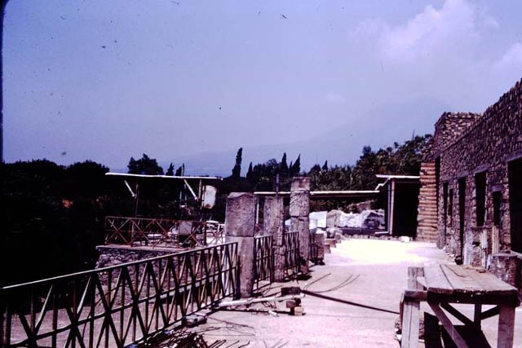 VII.16.17-22 Pompeii. 1977. Looking north along upper terrace portico, towards the House of the Golden Bracelet (VI.17.41-42). Photo by Stanley A. Jashemski.   
Source: The Wilhelmina and Stanley A. Jashemski archive in the University of Maryland Library, Special Collections (See collection page) and made available under the Creative Commons Attribution-Non Commercial License v.4. See Licence and use details. J77f0416

