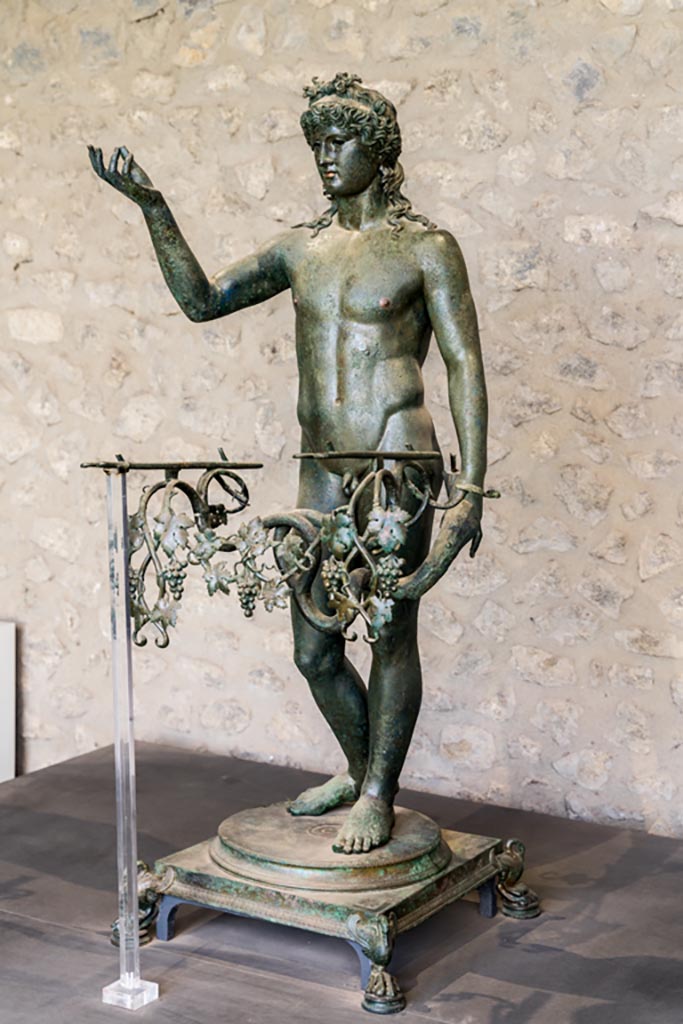 VII.16.17-22 Pompeii. January 2023. 
Bronze Ephebe lamp-holder (lampadophoro) from oecus 62, on display in exhibition in Palaestra.
Photo courtesy of Johannes Eber.
