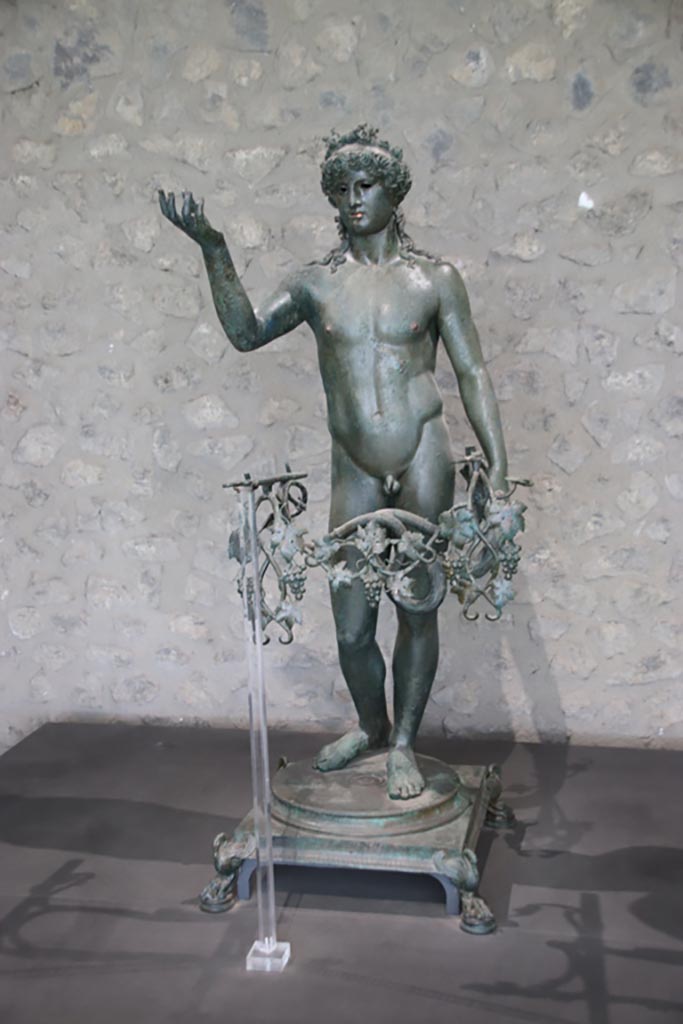 VII.16.17-22 Pompeii. October 2022. 
Bronze Ephebe lamp-holder, on display in exhibition in Palaestra. Photo courtesy of Klaus Heese. 
