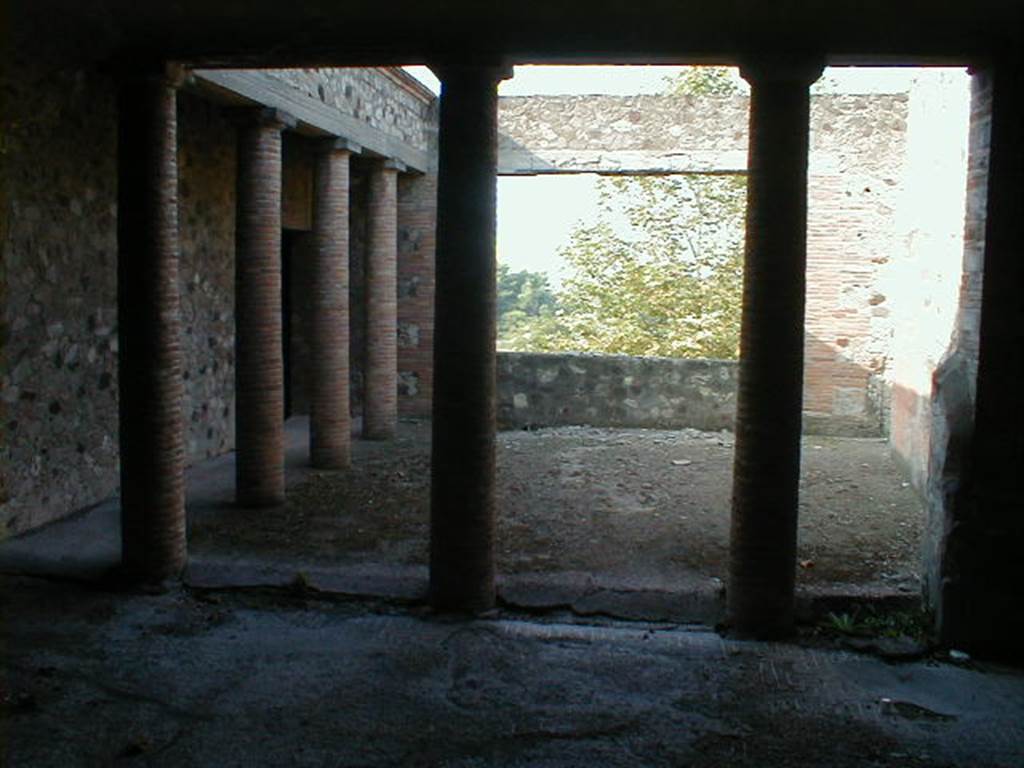 VII.16.17-22 Pompeii. December 2007. Peristyle 14, looking west across paved courtyard in House of Maius Castricius.
According to Jashemski, to the west of the peristyle garden was a paved courtyard with a portico on the south and the east.
A large window in the west wall looked down on the garden below, and to the Bay of Naples beyond.
This courtyard was probably decorated with potted plants and trees.
See Jashemski, W. F., 1993. The Gardens of Pompeii, Volume II: Appendices. New York: Caratzas. (p.203, C, and Fig. 237)


