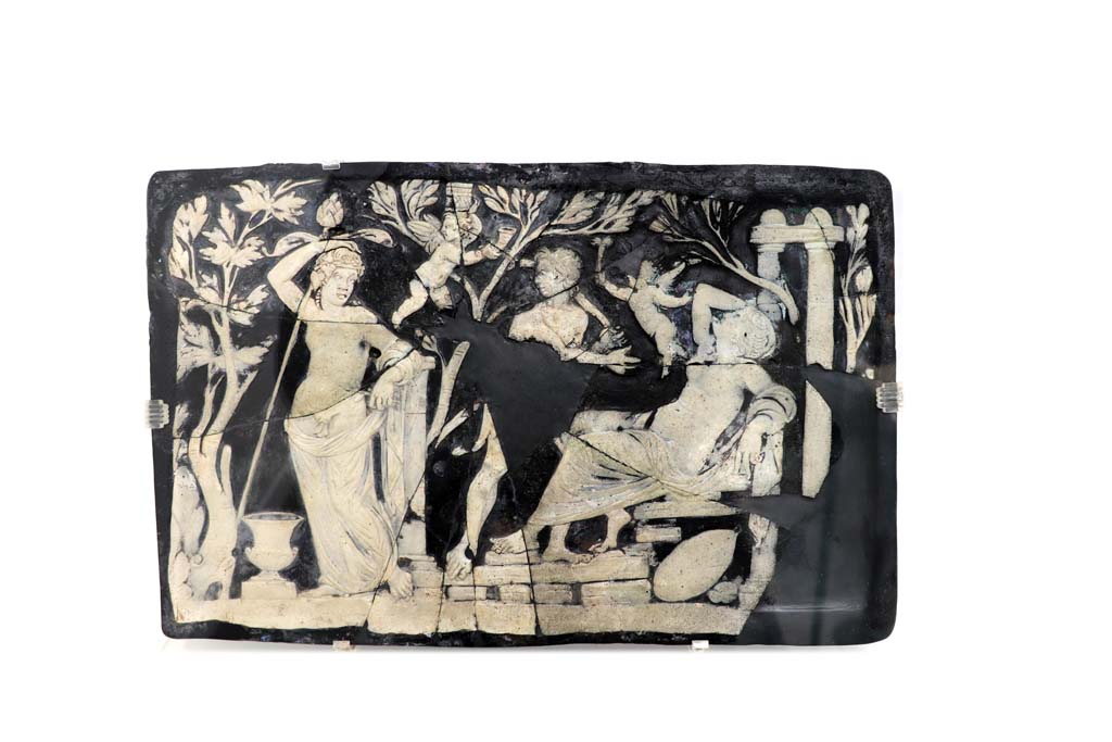 VII.16.17-22, Pompeii. May 2018. Found in the area outside the House of Fabius Rufus.
Cameo-glass panel, this panel possibly alluding to Ariadne’s initiation; a Maenad is pouring wine into her cup in the presence of a dancing Satyr.
Archaeological Park of Pompeii, inv. nos. 153651. Photo courtesy of Buzz Ferebee.

