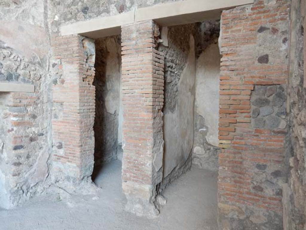 VIII.2.1 Pompeii. May 2018. Looking east in ala towards two doorways to cupboards in south-east corner of atrium.
On the left is the small doorway from the east oecus. Photo courtesy of Buzz Ferebee.

