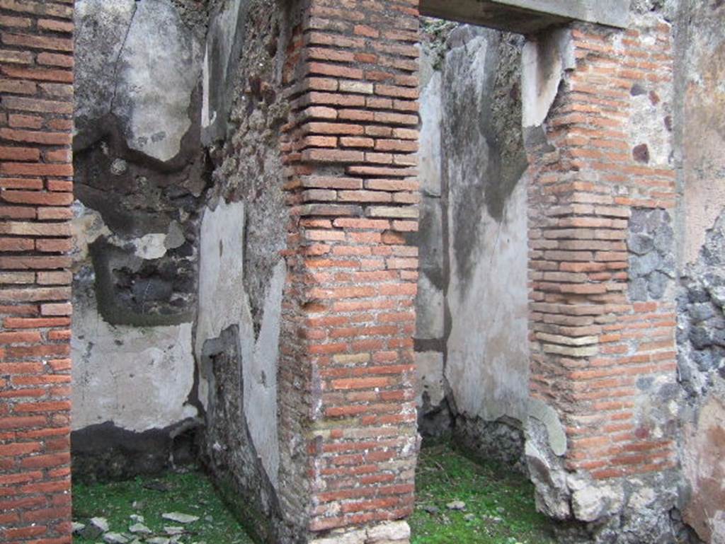 VIII.2.1 Pompeii. December 2005. Two doorways to small rooms or cupboards in south-east corner of atrium.