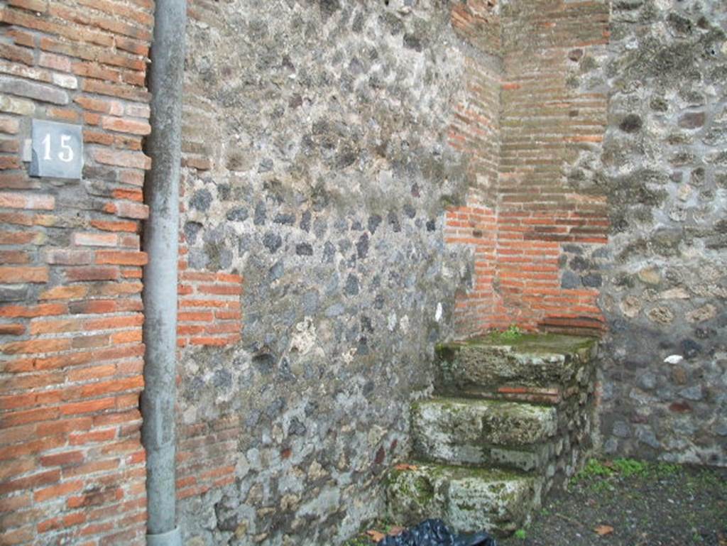 VIII.2.15 Pompeii. December 2004. South-west corner of shop, with three stone steps of base to upper floor.