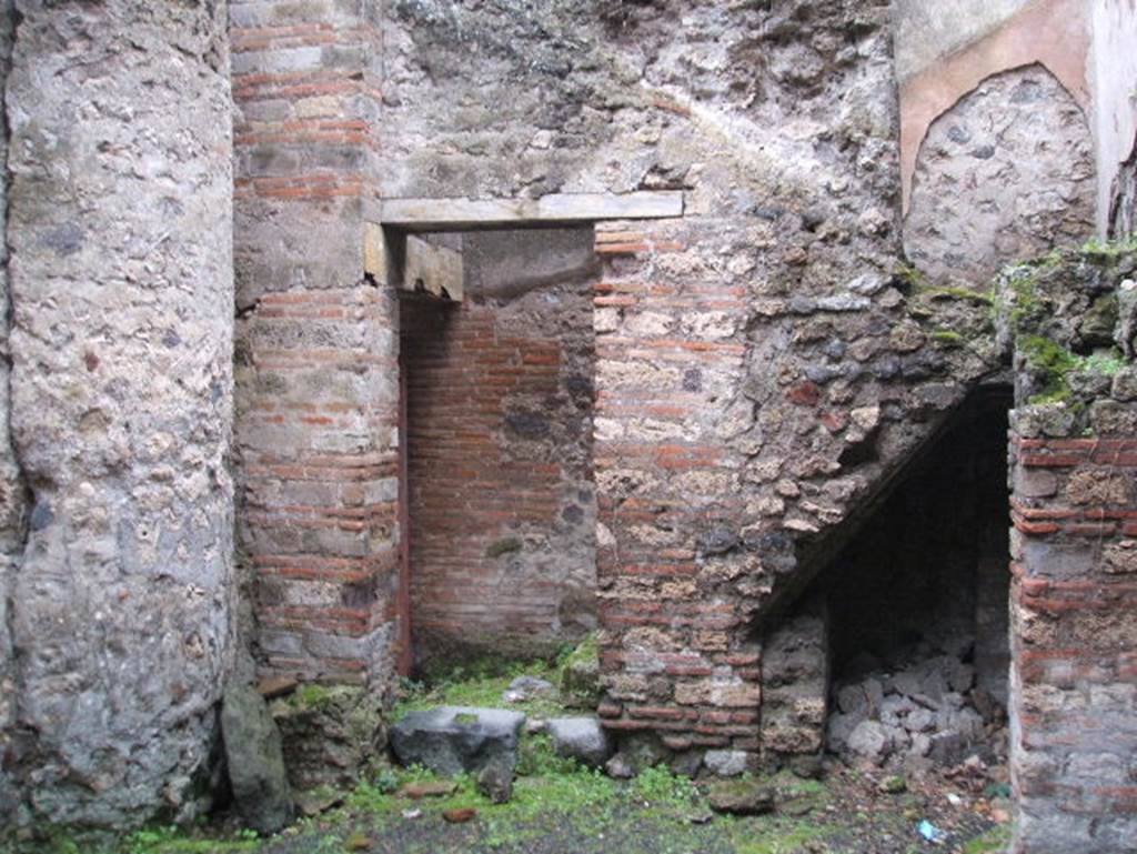 VIII.2.38 Pompeii. December 2004. Looking south to doorway to Kitchen and Steps to upper floor, with recess below.

