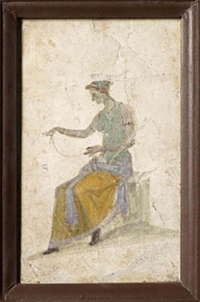 VIII.2.39 Pompeii. Room l on first lower floor. Painted panel from a cubiculum decorated in the Third style.
A seated female figure, intently tying thin threads or bandages for a sacred rite or for a spell of love.
Now in Naples Archaeological Museum. Inventory number 9523.
See Carratelli, G. P., 1990-2003. Pompei: Pitture e Mosaici. Vol. VIII. Roma: Istituto della enciclopedia italiana, p. 344-5. 
