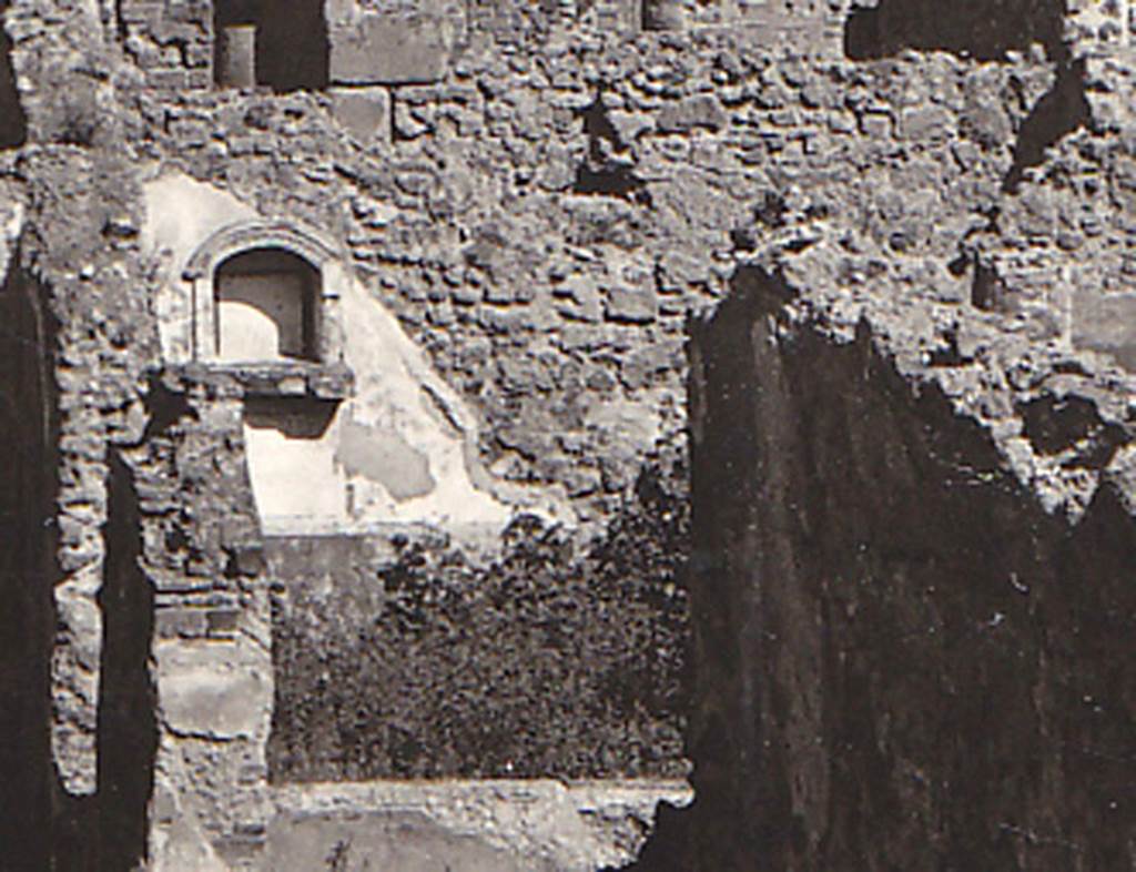 VIII.3.21 Pompeii. Detail of niche and garden from postcard dated 1st August 1939. 
According to Boyce, in the north wall of the garden was an arched niche adorned with an aedicula façade.
The façade had a modelled stucco cornice running around the curve of the arch.
It also had a heavy ledge projecting from the wall.
The inside walls of the niche were covered with white stucco and outlined with red stripes.
See Boyce G. K., 1937. Corpus of the Lararia of Pompeii. Rome: MAAR 14. (p.76, no.356, & Pl.3,5 photo by Warscher).
Photo courtesy of Drew Baker
