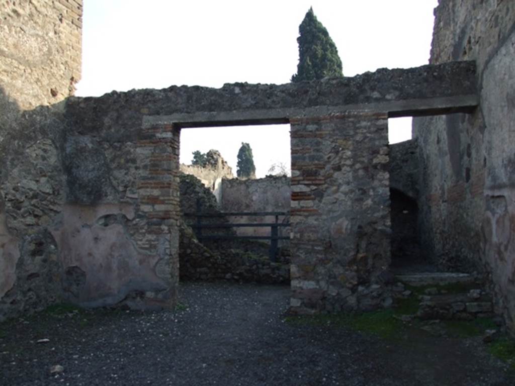VIII.4.7 Pompeii. December 2007. 
Looking towards south wall and doorway to rear room and two masonry steps that lead to wooden steps for access to upper floor.


