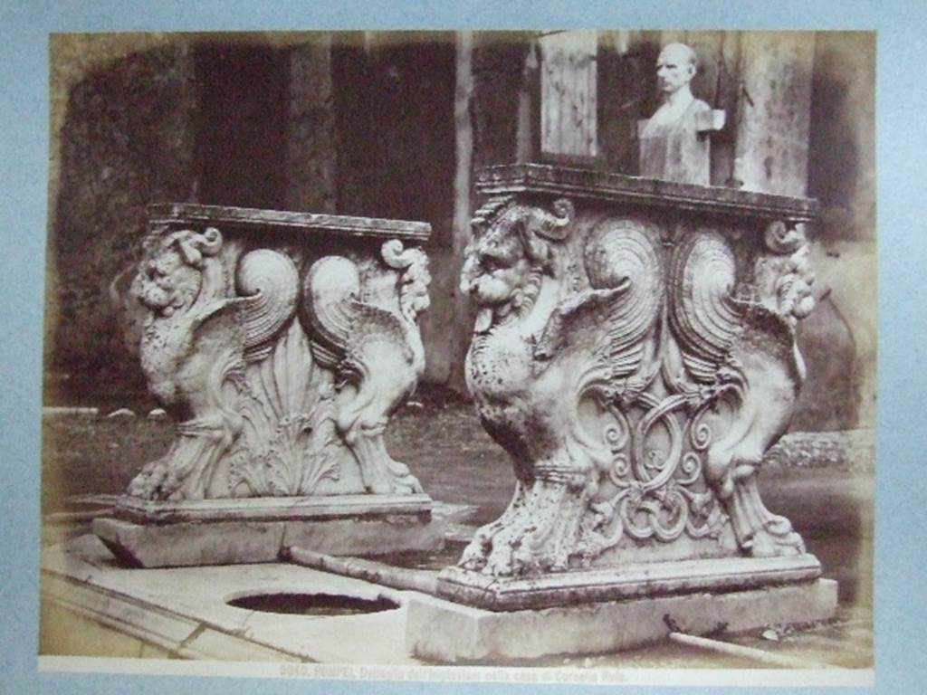 VIII.4.15 Pompeii.  Supports of marble table or cartibulum. Bust and herm of C Cornelio Rufo  are in background. Undated photograph. Courtesy of Society of Antiquaries. Fox Collection.
