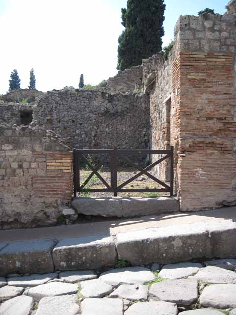 VIII.7.23 Pompeii. September 2010. ID number plate on north side of entrance. Looking north along Via Stabiana. Photo courtesy of Drew Baker.
