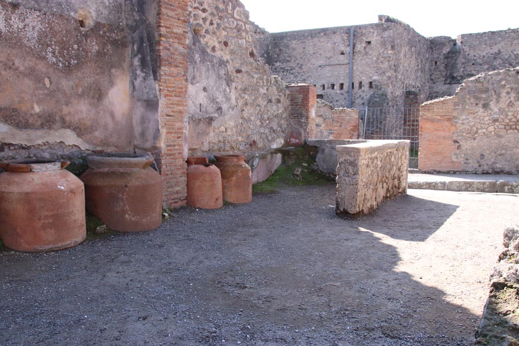 IX.1.3 Pompeii. October 2022. 
Looking south-west towards rear of counter, and entrance onto Via Stabiana. Photo courtesy of Klaus Heese

