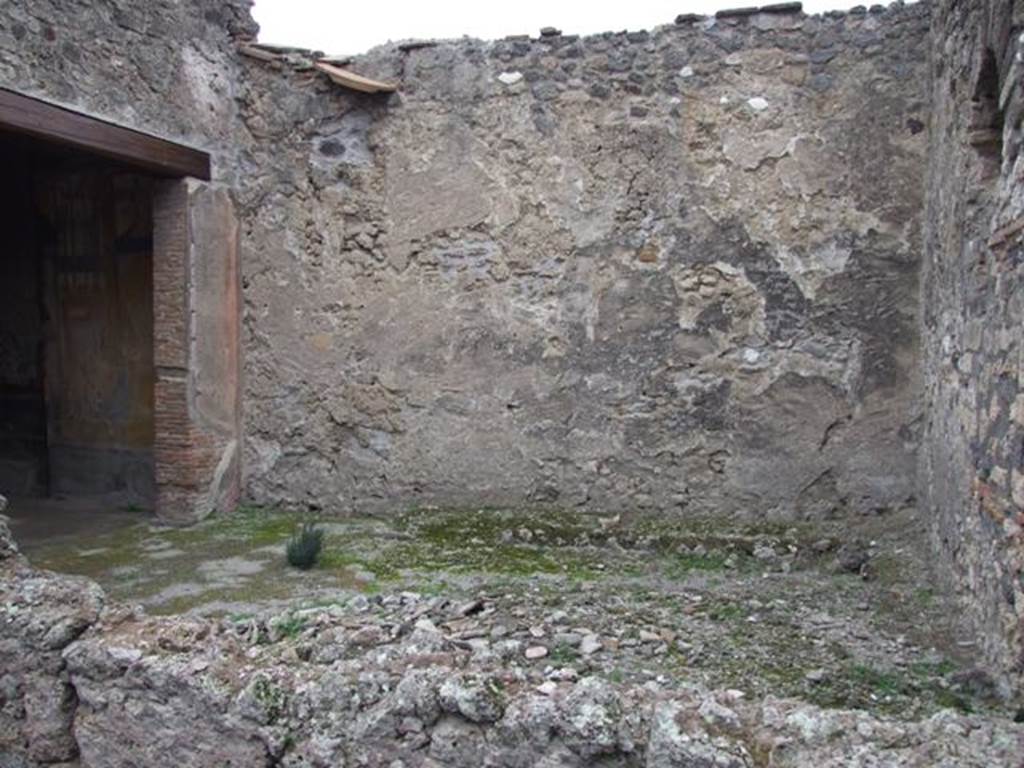 IX.1.7 Pompeii. December 2007. Garden area, looking north. According to Jashemski, 
“the small garden to the left of the atrium had a raised planting bed attached to the wall at the edge of the garden, on the east and on much of the north wall. The low wall with space for plants continued on the south side, separating the garden from the atrium. The house was small but well decorated. Two marble tondi (Naples inventory 109 288, and 6622) were found in the garden; the marble Herm of Bacchus (Naples inv. 109 518) and the marble Statuette of Attis attached to a little support (Naples inv. 120 402), as well as 2 marble pine-cones (fountains ?) may have been garden decorations. The triclinium on the west opened onto the garden. There was also an entrance doorway to the garden from the atrium”.
See Jashemski, W. F., 1993. The Gardens of Pompeii, Volume II: Appendices. New York: Caratzas. (p.225)

According to Lucia Anna D’Acunto, the following marble objects were found in this garden, atrium and second room to the left. Marble disc (Oscillum), found in garden on 21.4.1857, Naples Inventory number 6622. White marble decorative shield (Clipeo) found in garden on 2.8.1871, Naples inventory number 109288. Herm of Dionysius, found in second room to the left on 28.5.1866, Naples inventory number 109518. Table support (Trapezoforo) of a young boy with phrygian cap, found in atrium on 3.5.1866, Naples inventory number 120402.
See Pompeian marble in the Naples Museum (SAP book 26), by Carrella, A; D’Acunto, L.A; Inserra, N; and Serpe, C. (p.160-2)
