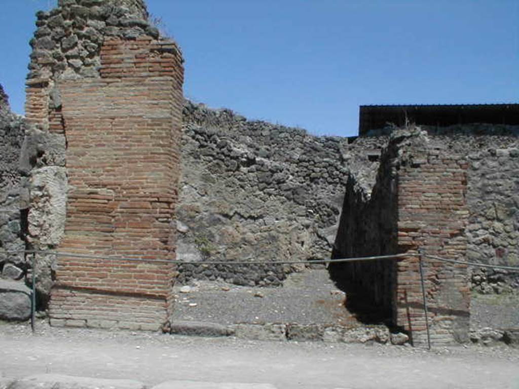 IX.1.9 Pompeii. May 2005. Entrance on Via Stabiana, looking east.
According to Della Corte, found on the pilaster between IX.1.9 or IX.1.10, on the right, was a painted recommendation, 
Faustinum aed(ilem)
Fabritius  rog(at)    [CIL IV 958 ]
He said he could not know which of the two shops this Pompeian was established in.
See Della Corte, M., 1965.  Case ed Abitanti di Pompei. Napoli: Fausto Fiorentino. (p.210) (see also IX.1.10) 
A bronze cooking pot without a handle, 36cm high, was found in this shop.
See Gallo, A (2001). Pompei, L’Insula I della Regione IX, Settore Occidentale (p.61), in SAP book no. 1 (L’Erma di Bretschneider)
