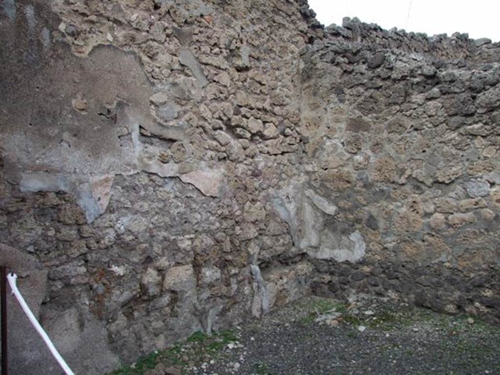 IX.1.9 Pompeii. December 2007. North wall, and north-east corner of shop, with very small remains of base of steps to upper floor.