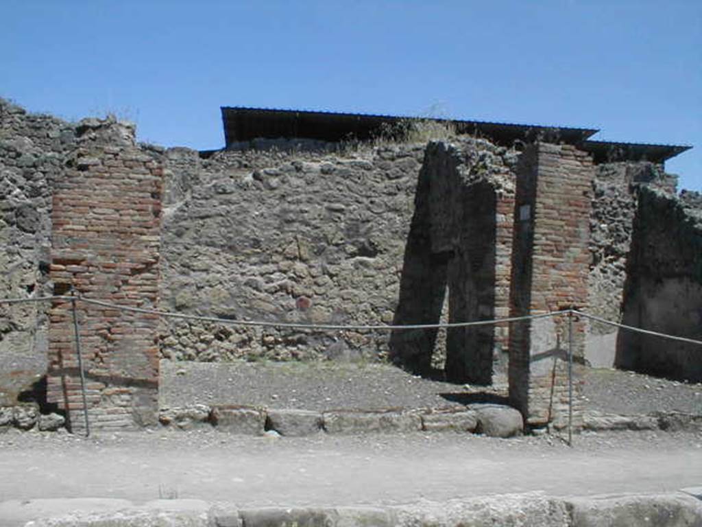 IX.1.10 Pompeii. May 2005. Entrance on Via Stabiana, looking east.
According to Della Corte, found on the pilaster between IX.1.9 or IX.1.10, pilaster on the left, was a painted recommendation, 
Fabritius  rog(at)    [CIL IV 958 ]
He said he could not know which of the two shops this Pompeian was established in.
See Della Corte, M., 1965.  Case ed Abitanti di Pompei. Napoli: Fausto Fiorentino. (p.210).
According to Pagano and Prisciandaro, the graffiti in black was found at IX.1.11 in July 1853.  This was probably the pilaster on the right between IX.1.10 and IX.1.11, and read:
Faustinum aed(ilem)
Fabritius rog(at)  [CIL IV 958]
See Pagano, M. and Prisciandaro, R., 2006. Studio sulle provenienze degli oggetti rinvenuti negli scavi borbonici del regno di Napoli. Naples : Nicola Longobardi. (p.169)
For the list of bronze, iron,terracotta, glass, bone and amphorae found in this shop,
See Gallo, A (2001). Pompei, L’Insula I della Regione IX, Settore Occidentale (p.61), in SAP book no. 1 (L’Erma di Bretschneider)
