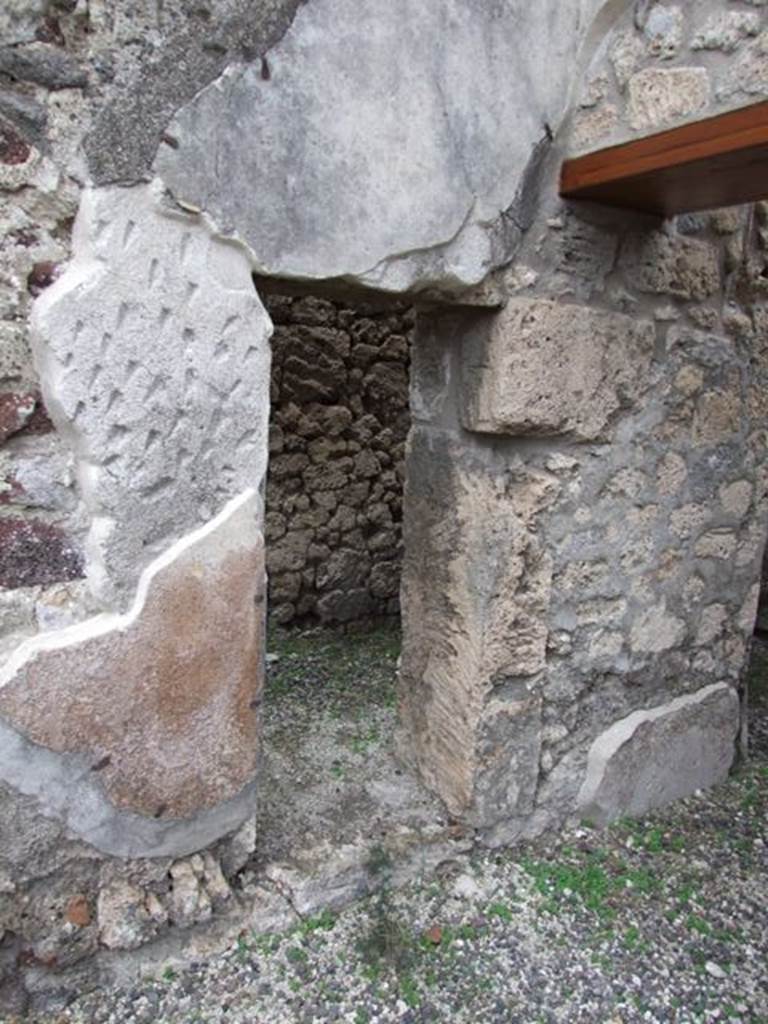 IX.1.12 Pompeii. December 2007.  Small doorway in east wall of south east corner of atrium, leading to room with stairs of wood.


 
