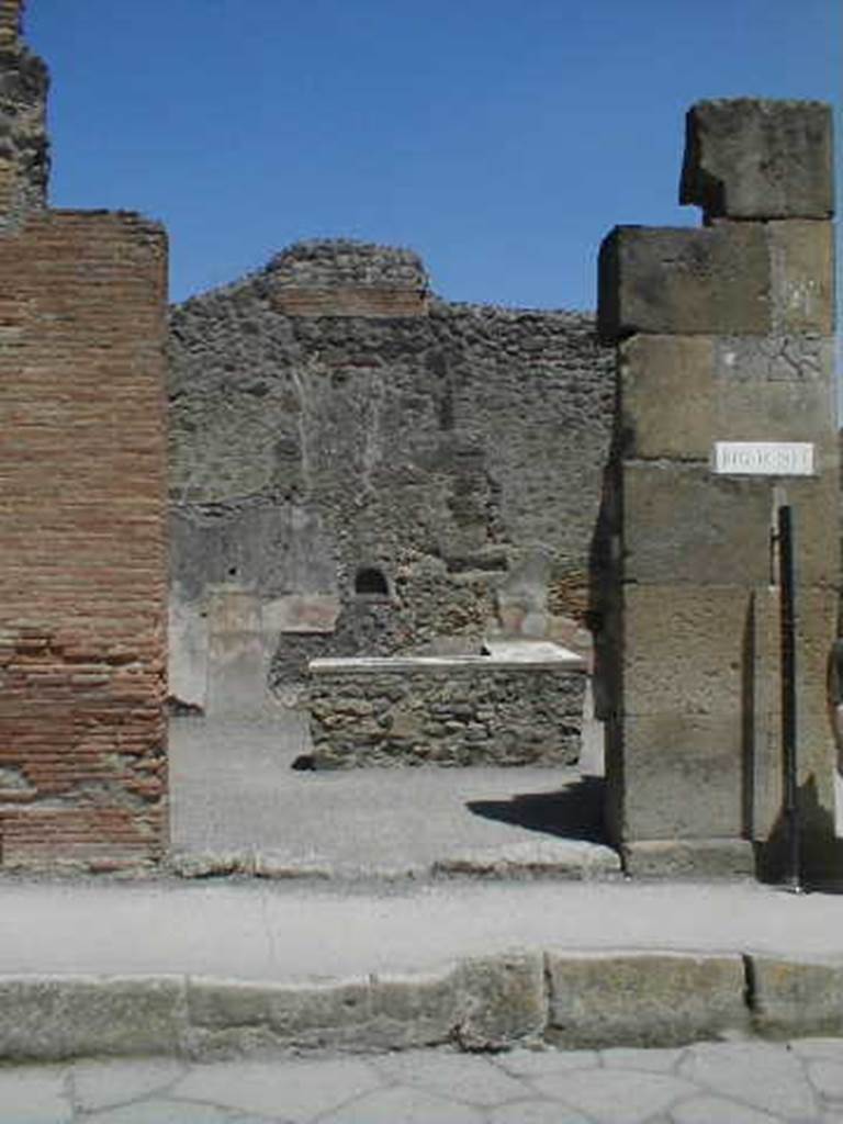 IX.1.15 Pompeii. May 2005. Entrance on Via Stabiana. Looking east.
According to Della Corte, this was a large caupona of the usual form with rear and upstairs room.  He thought it would have been in the possession of a Primus, according to the recommendations written on the left of entrance IX.1.15.

A(ulum)  Vettium  Caprasium
Felicem  aed(ilem)  Primus  rog(at)      [CIL IV 953]       

M(arcum)  Holconium  Priscum 
aed(ilem)  primus  rog(at)  Proculu(s)      [CIL IV 966] 
See Della Corte, M., 1965.  Case ed Abitanti di Pompei. Napoli: Fausto Fiorentino. (p.210)

