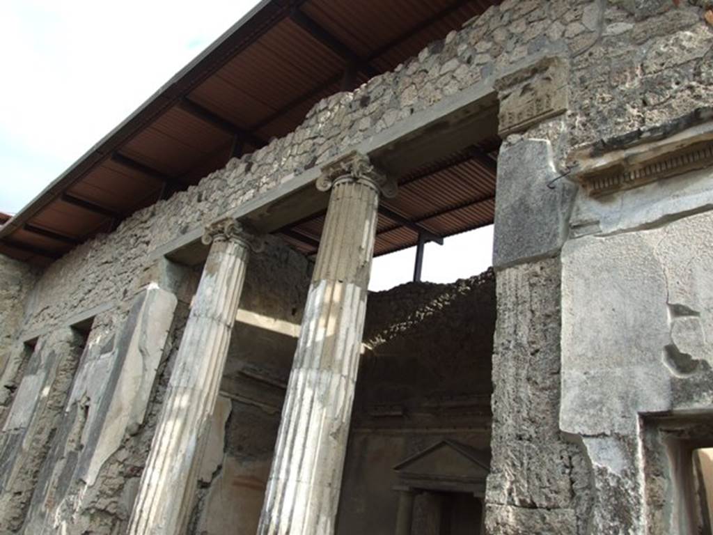 IX.1.20 Pompeii.  December 2007.  Room 2.  Atrium on east side.  Room 6 Ala, with household shrine, 2 Ionic columns in opening, and figured capitals on either side.
