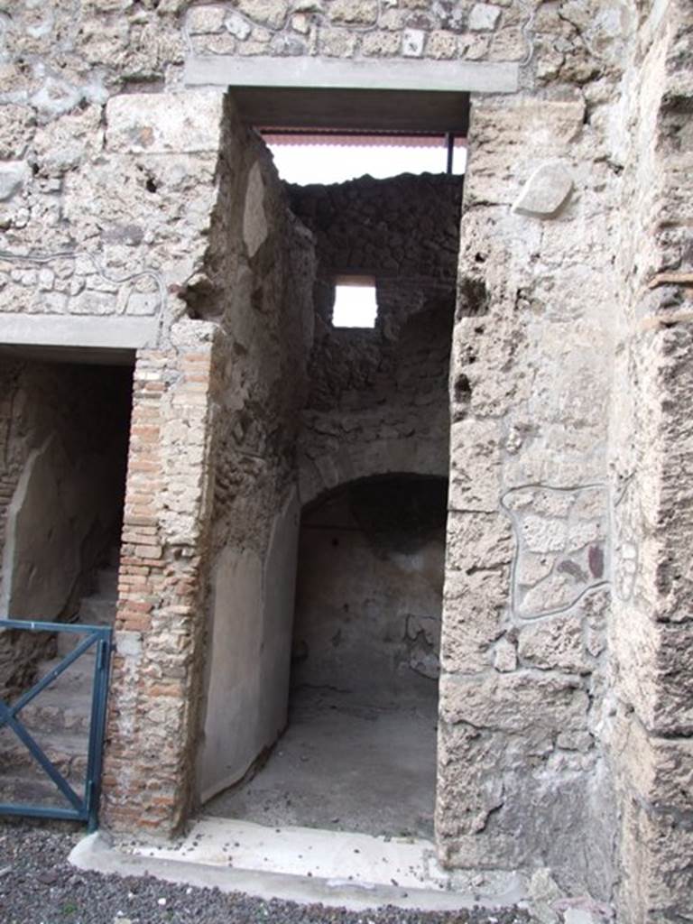 IX.1.20 Pompeii.  December 2007.  Doorway to Room 15, with staircase to upper floor visible above the arch at rear.

