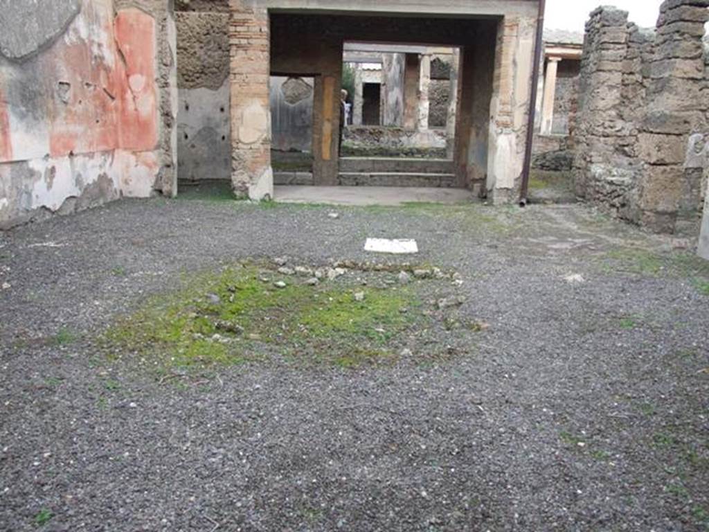 IX.1.22 Pompeii. December 2007. Room 1, atrium looking north to room 7. According to Schone in BdI, “In the atrium because the floor was ruined, a large cistern was revealed.
The atrium showed the usual proportions and regular arrangement, except for the fact that the usual rooms to be found on the left side were missing. The walls were simply decorated in red, divided by distinct white stripes with some colourful ornament. On the second of these stripes to the left, there was a graffito “sabinis”, which was the only oscan inscription found in these excavations.”
See BdI, 1867, p.47-48
