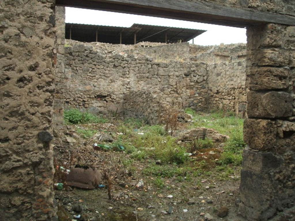 IX.1.28 Pompeii. May 2005. Entrance, looking west towards two rear rooms, and a latrine. 
According to Eschebach, at the rear were two cubicula for grooms and a latrine beneath the stairs to the upper floor. See Eschebach, L., 1993. Gebudeverzeichnis und Stadtplan der antiken Stadt Pompeji. Kln: Bhlau. (p.
The wall on the right of the entrance doorway used to show the graffito: 
L(ucium)  Albucium  aed(ilem)
Thesmus  libert(us)  rog(at)    [CIL IV 2983]
Della Corte made the comment that probably Thesmus was a freedman of the candidate L. Albucius (Celsus) and he was showing his support in CIL IV 2983.
See Della Corte, M., 1965.  Case ed Abitanti di Pompei. Napoli: Fausto Fiorentino. (p. 212)

