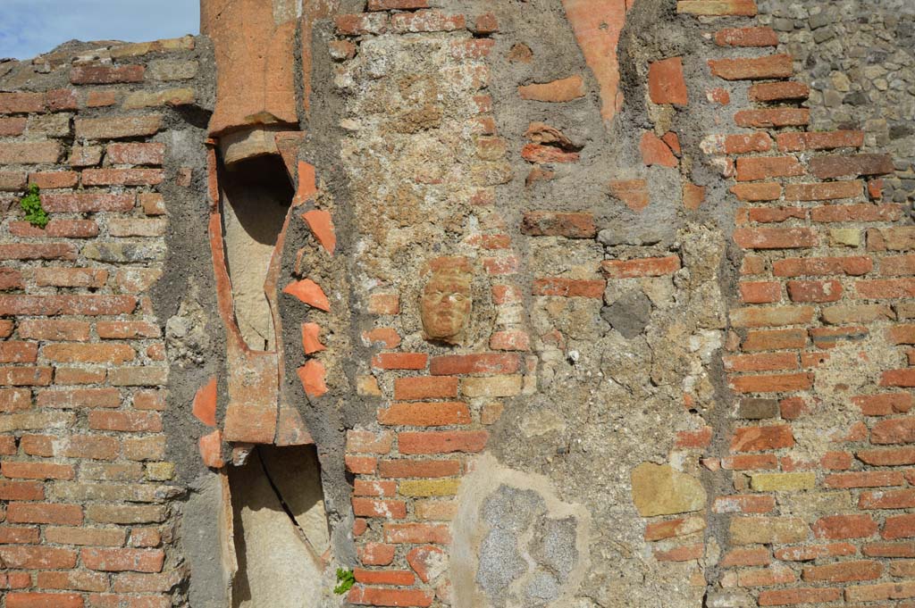 IX.2.2, on left, and IX.2.3, on right. March 2018. 
Central pilaster with downpipe. In the centre of the pilaster is a small terracotta face.
Foto Taylor Lauritsen, ERC Grant 681269 DCOR.
