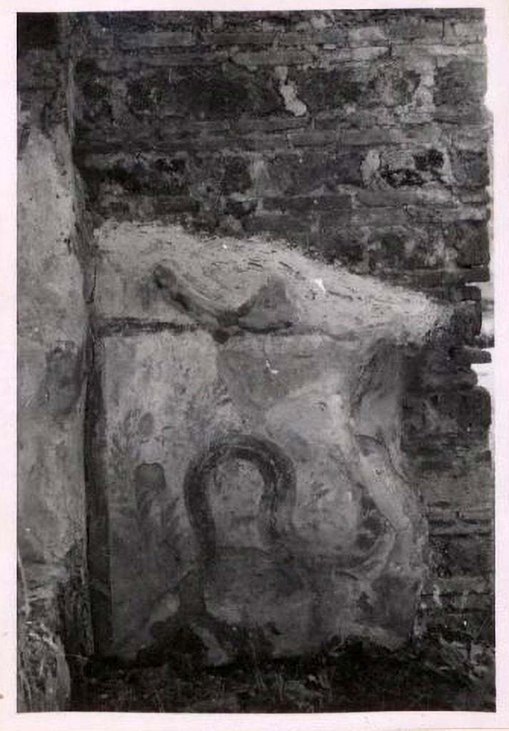 IX.2.6 Pompeii. Pre-1943. Photo by Tatiana Warscher.
According to Warscher, quoting Fiorelli 
In a rear room (b), on the west wall, is a fragmentary panel of white stucco bordered in red, on which is painted a single red serpent coiling among plants.
See Warscher, T. Codex Topographicus Pompeianus, IX.2. (1943), Swedish Institute, Rome. (no.15a.), p. 39.
Boyce records:
391
IX, ii, 6
Taberna. 1n a rear room, on the W. wall, is a fragmentary panel of white stucco bordered in red, on which is painted a single red serpent coiling among plants.
FIORELLI, Scavi, 55.
392.
IX, ii, 7
Taberna. In the S. wall is a rectangular niche (h. 0.82, w. 0.44, d. 0.22, h. above the floor 1.45) - the lararium, according to the report.
Bull. Arch. Nap., N. S., i, 1853, 25.
See Boyce G. K., 1937. Corpus of the Lararia of Pompeii. Rome: MAAR 14, p. 80, no. 391, no. 392.


