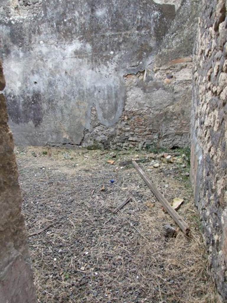 IX.2.16 Pompeii. December 2007. Doorway to room on south side of corridor, described by Boyce as the triclinium. He said that on the north wall was a panel of white stucco bordered in red and within it was the lararium painting in two zones. The two Lares stood in the upper zone, both with rhyton and situla, and the Genius stood between them pouring a libation onto an altar. On the other side of the altar was the tibicen.  In the lower zone, one yellow serpent was advancing left towards a painted altar of yellow marble with one egg.
See Boyce G. K., 1937. Corpus of the Lararia of Pompeii. Rome: MAAR 14.  (p.81, no.394)
According to Trendelenburg in BdI, from the fauces, a side door gave access to a square room. The original decoration was not conserved, other than some traces of figurines placed in the red and black divisions on the wall, and the painted lararium divided into two zones.
See Trendelenburg in BdI, 1871, (p.201)
According to Fiorelli, Dal tablino, e dalla fauce che vi si trova accanto, nel cui estremo e situato il triclinio, si passa nel giardino, che ha un larario. From the tablinum, and from the corridor that one finds nearby, in whose extremity was situated the triclinium, one passes into the garden, that had a lararium with the painting of a Genius sacrificing being assisted by a tibicen. There were also two Lares and a serpent advancing towards the table. Following on was a storeroom (apotheca), a masonry staircase to the upper floor, the kitchen and the latrine, placed beneath the abovementioned stairs, and another room, occupied perhaps by a servant that guardedthe door.
See Pappalardo, U., 2001. La Descrizione di Pompei per Giuseppe Fiorelli (1875). Napoli: Massa Editore. (p.142-3)
See Fiorelli, G., 1875. Descrizione di Pompei, (p.384)

According to Giacobello, the picture was in an apotheca (o) on the north wall, but is no longer visible, only Boyces description remains.
See Giacobello, F., 2008. Larari Pompeiani: Iconografia e culto dei Lari in ambito domestico.  Milano: LED Edizioni. (p.204-5)
