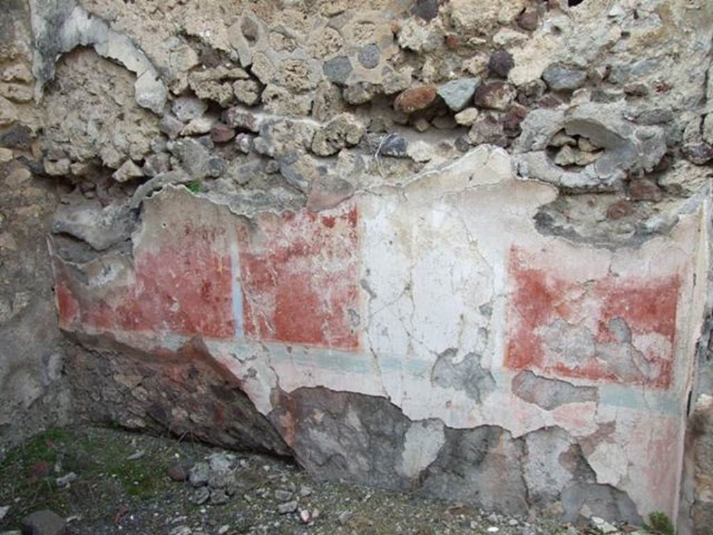 IX.2.21 Pompeii. March 2009. Room 13, north wall of cubiculum. According to Bragantini, the dado would have been red, and in the middle zone of the north wall was a white central aedicula. On both sides of it, the panels were red. The upper zone of the wall would have been white. The panel on the west end was sub-divided by a candelabra which formed the recess wall. At the base of the middle zone was an azure blue line. In the white panel, a painted female figure near an archaic herm of Dionysus, was seen.
See Sogliano, A., 1879. Le pitture murali campane scoverte negli anni 1867-79. Napoli: Giannini. (p.52, no.243) 
See Bragantini, de Vos, Badoni, 1986. Pitture e Pavimenti di Pompei, Parte 3. Rome: ICCD. (p.424, cubicolo m)
