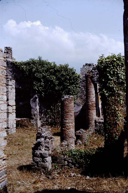 IX.2.27 Pompeii. May 2010. Looking south-east from entrance across the remains of the portico towards the workshop.