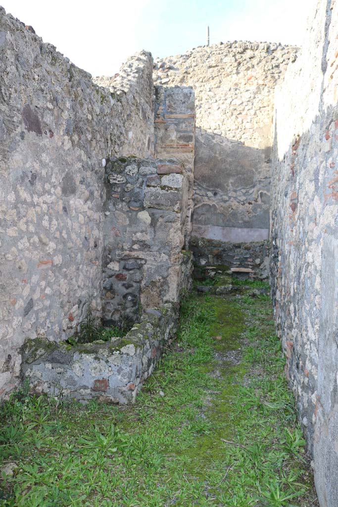 IX.3.14 Pompeii. December 2018. 
Looking north along corridor to rear on west side, containing the fusorium, hearth and the latrine.
Photo courtesy of Aude Durand.
