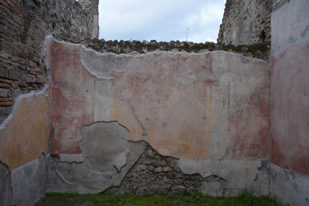 IX.5.9 Pompeii. March 2017. Room p, looking towards east wall.
Foto Christian Beck, ERC Grant 681269 DCOR.
According to PPM 
The east wall was decorated in IV style with panels with painted plants in a high black zoccolo, and in the middle zone, the central panel was yellow and the side panels were red, separated by architecture; the carpet borders on the side panels continued onto the nearby panels on the next wall in the manner to give the impression that large panels enclosed the entire room as a unit. 
See Carratelli, G. P., 1990-2003. Pompei: Pitture e Mosaici. IX (9). Roma: Istituto della enciclopedia italiana, (p.525).

