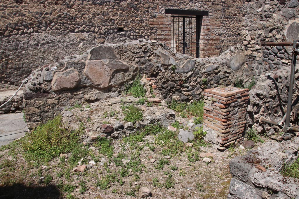 IX.6.7 Pompeii. May 2005. 
Looking south from entrance doorway, into large kitchen (room p on plan) with remains of hearth (on left of entrance doorway under the window), a tub/basin against the east wall and doorway to room s on east side of peristyle of IX.6.5.  According to Mau, the entrance doorway (at IX.6.7) was originally 2,11 wide so he assumed that here, at one time, some industry was done, but that it was later narrowed to 1.06. In the last times of the house, "p" was the kitchen with hearth leaning against the north wall, and above it was a square window.  Against the east wall, a tub/basin was leaning (2.24 x 0.76 measured externally, and 0,65 high) with a hole near the bottom, which, however, was completely filled with various stones added with mortar: room "q" was the latrine with small window that narrowed towards the vicolo; rooms "r" and "s" could be considered as cupboards/storerooms and each had a window into the kitchen, which for its part had a small window near to the south-west corner onto the peristyle, and in the same corner a niche (0.40 high x 0.33 wide) that could have been used as a lararium or for putting a light, or for the figurines of the Lares: a lararium painting was not found.
See Mau in BdI 1880, (p.231)
According to Boyce, in the west wall was a small niche which may have been used for either lamp or lararium.
See Boyce G. K., 1937. Corpus of the Lararia of Pompeii. Rome: MAAR 14. (p.86, no. 431).
According to Della Corte, the following electoral recommendation was found here -
Oppius (Gratus) rog(at)  [CIL IV 3696]  (see note 3 on page 164)
See Della Corte, M., 1965.  Case ed Abitanti di Pompei. Napoli: Fausto Fiorentino.(p.164)
According to Epigraphik-Datenbank Clauss/Slaby (See www.manfredclauss.de), this read as 
Oppiu<s>  Severum  aed(ilem)    [CIL IV 3696]




