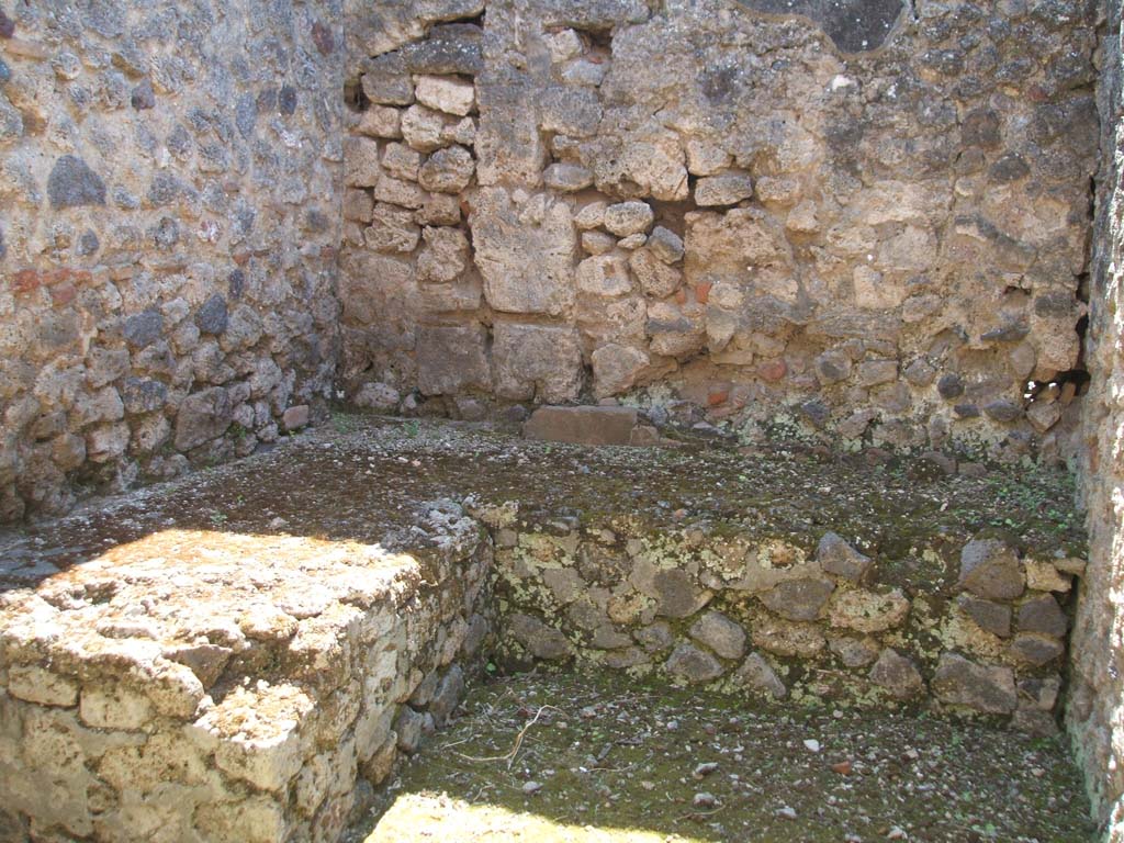 IX.7.20 Pompeii. May 2005. Kitchen room (p). L-shaped two-sided stone hearth or bench, against east and south wall.