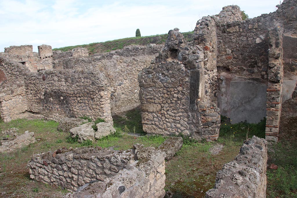 IX.7.21 Pompeii. October 2024. Looking north-east across atrium from above corridor to latrine. Photo courtesy of Klaus Heese.