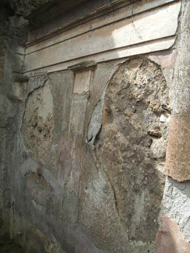 IX.7.25 Pompeii. May 2005. West wall of garden area “u”, with remains of moulded cornice. 
According to Jashemski, Mau had said on the south garden wall (not photographed here), to the right (west) of the door leading to a back room, there was a painting of a kind of pavilion.
This was formed by four columns in which stood a large crater fountain (79cm high).
It was decorated with plant and animal motifs in high relief.
The jetting water fell back into the crater from a height of about 20cm.
Fortunately, Tatiana Warscher had photographed the now-destroyed detail.
She said this was found “at the base of the middle of the garden wall”.
Nothing remains today.
See Jashemski, W. F., 1993. The Gardens of Pompeii, Volume II: Appendices. New York: Caratzas. (No.96 on p.366).
The Tatiana Warscher photograph can be seen on page 367, fig.430 of the same book.
Jashemski also included a mosaic fountain at IX.7.25, that we have included in IX.7.20, see Pt. 5.
See Jashemski, W. F., 1993. The Gardens of Pompeii, Volume II: Appendices. New York: Caratzas. (p.242).
See Boyce G. K., 1937. Corpus of the Lararia of Pompeii. Rome: MAAR 14. (p.89, no.446, he gives the location as IX.7.?) 
