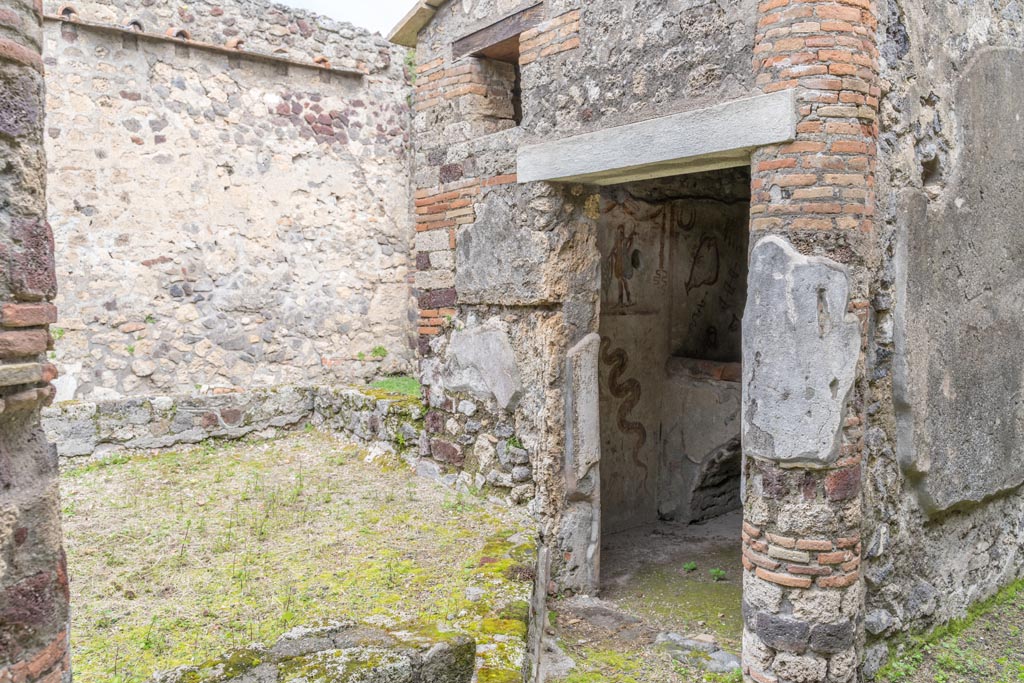 IX.9.c Pompeii. March 2023. Doorway into kitchen at east end of peristyle/garden. Photo courtesy of Johannes Eber.