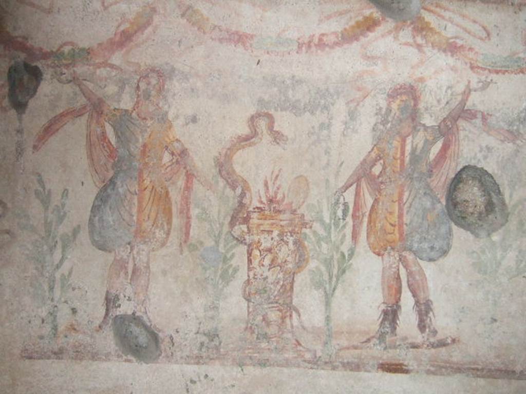 IX.9.c Pompeii. December 2005.  Kitchen.  Lararium painting.   
Two Lares either side of a round altar which has a snake winding round it.
