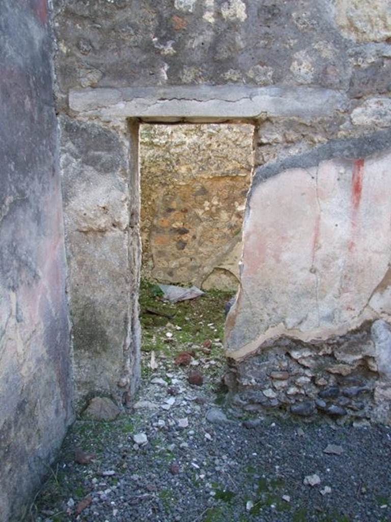 IX.9.d Pompeii. March 2009. Room l, triclinium/oecus.  
Looking towards a small doorway in west wall, leading to room m.
According to NdS, originally the oecus would have had a doorway linking to the adjacent cubiculum, then the doorway was reduced it seemed to a small window.
In the centre of the west wall a painting of Io and Argo was recognised.
(See Helbig, W., 1868. Wandgemälde der vom Vesuv verschütteten Städte Campaniens. Leipzig: Breitkopf und Härtel. (no.131-34))
Io was seen sitting on the left, turning her head to the right to look at Argo, who in this painting was armed with a spear.
The figure of Argo was badly damaged, while that of Io was better preserved, wearing a necklace, yellow chiton without sleeves, a purple mantle wrapped around her legs.
Average height of figures was 0.48m.
See Notizie degli Scavi, 1889, p.132.
