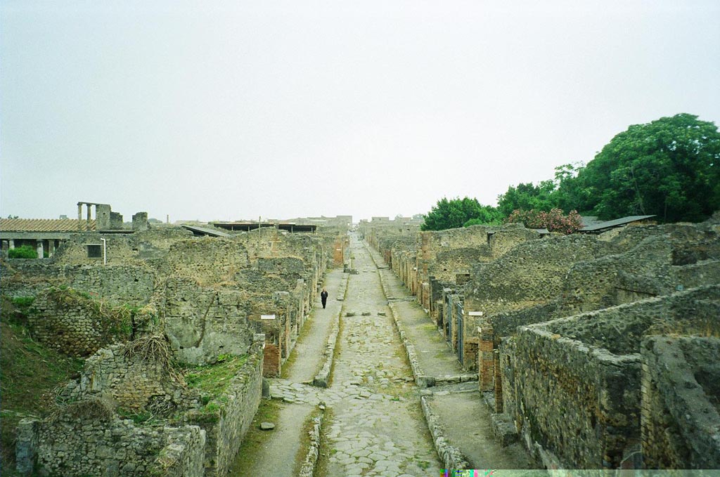 IX.10.1 Pompeii. May 2010. 
Entrance fauces 1, cubiculum 3 and bred making room 4 and oven 7a are partly visible on the left of the Via di Nola. Photo courtesy of Rick Bauer.

