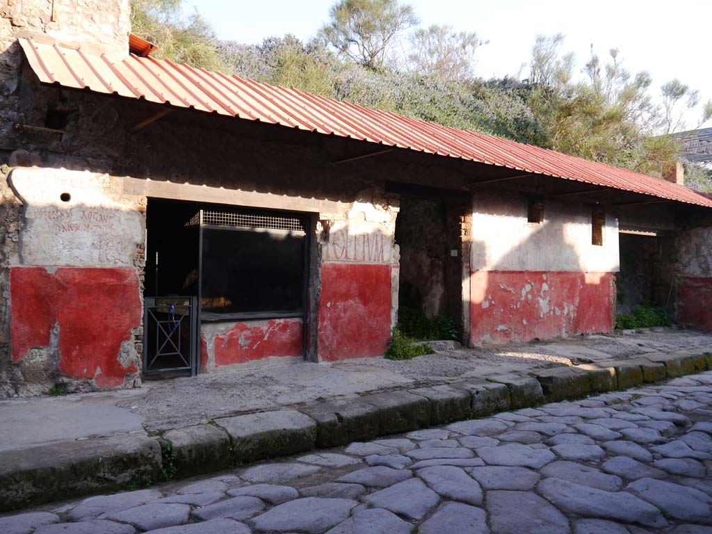 IX.11.2 Pompeii, in centre. October 2023. 
Entrance doorway with painted graffiti on both sides, with IX.11.3, on right. Photo courtesy of Johannes Eber.
