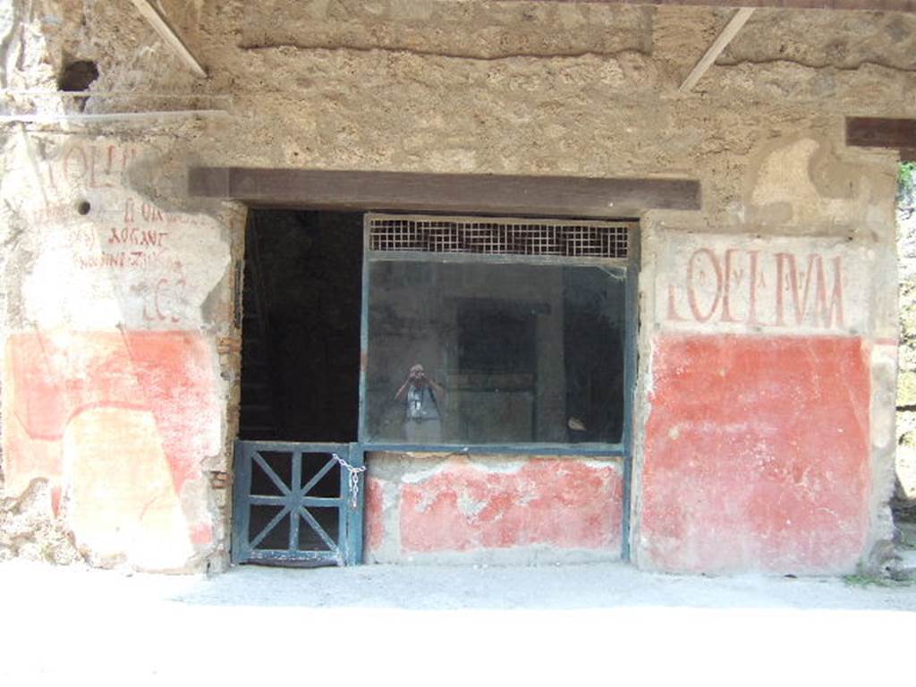 IX.11.2 Pompeii. December 2006. Entrance on Via dell’Abbondanza.
According to Cooley, found between IX.11.1 and 2, on the left of the entrance above, was the graffiti CIL IV 7862. It is no longer there.
She translates it as “I beg you to elect Cn. Helvius Sabinus aedile, worthy of public office. Aegle asks for this” See Cooley, A. and M.G.L., 2004. Pompeii : A Sourcebook. London : Routledge. (p.123, F57, where she numbers it as CIL IV 7886)
Found either to the left or right of the doorway, was CIL IV 7866, but this too is no longer there. According to Cooley, this translated as -
“I beg you to elect Cn. Helvius Sabinus aedile, worthy of public office. Maria asks for this”  See Cooley, A. and M.G.L., 2004. Pompeii : A Sourcebook. London : Routledge. (p.123)
According to Della Corte, Aegle, Maria and Zmyrina are all assumed to have been servant girls of Asellina, and are all named in the graffiti on the exterior wall. See Della Corte, M., 1965.  Case ed Abitanti di Pompei. Napoli: Fausto Fiorentino.    (p.308)
According to Epigraphik-Datenbank Clauss/Slaby (See www.manfredclauss.de), these  read –
Cn(aeum)  Helvium  Sabinum
aed(ilem)  d(ignum)  r(ei)  p(ublicae)  o(ro)  v(os)  f(aciatis)   Aegle  rogat      [CIL IV 7862]
Cn(aeum)  Helvium  Sabinum
aed(ilem)  d(ignum)  r(ei)  p(ublicae)  o(ro)  v(os)  f(aciatis)   Maria rogat       [CIL IV 7866]

