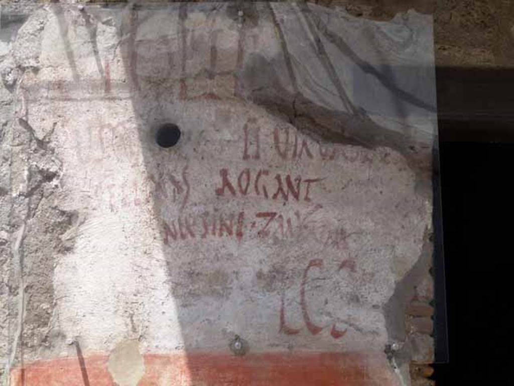 IX.11.2 Pompeii. May 2017. Graffiti on west side of entrance. Photo courtesy of Buzz Ferebee.

