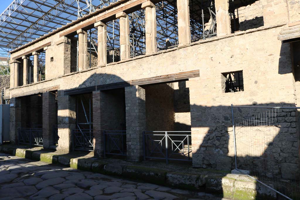 IX.12.1-5 Pompeii. December 2018. Looking west along front faade, with IX.12.5, centre right. Photo courtesy of Aude Durand.