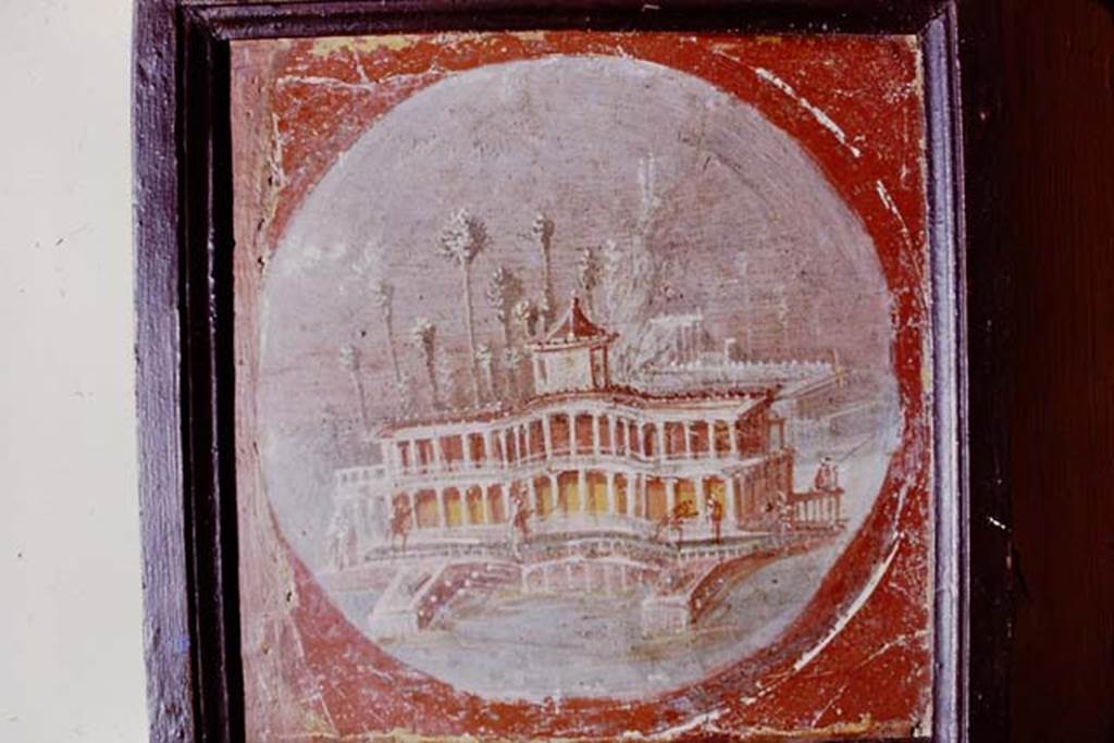 Villa San Marco, Stabiae, 1975. Medallion from room 20, showing a maritime villa.
Now in Naples Archaeological Museum. Inventory number 9511. Photo by Stanley A. Jashemski.   
Source: The Wilhelmina and Stanley A. Jashemski archive in the University of Maryland Library, Special Collections (See collection page) and made available under the Creative Commons Attribution-Non Commercial License v.4. See Licence and use details. J75f0551
