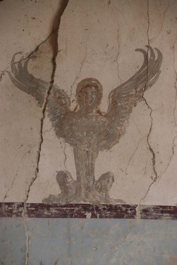Villa San Marco, Stabiae, September 2019. Room 57, detail of painting of sphynx at top of centre panel of east wall. 
Photo courtesy of Klaus Heese.
