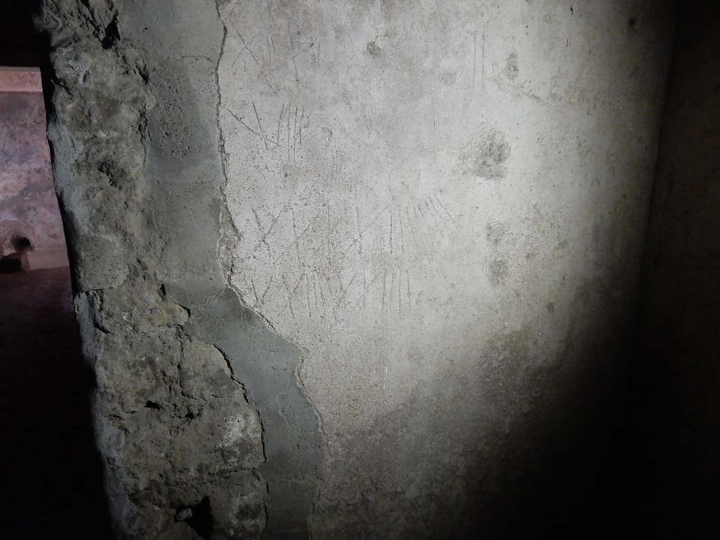 Villa San Marco, Stabiae, June 2019. Room 26, graffiti of Roman numerals on south wall in south-west corner of kitchen.
 Photo courtesy of Buzz Ferebee
