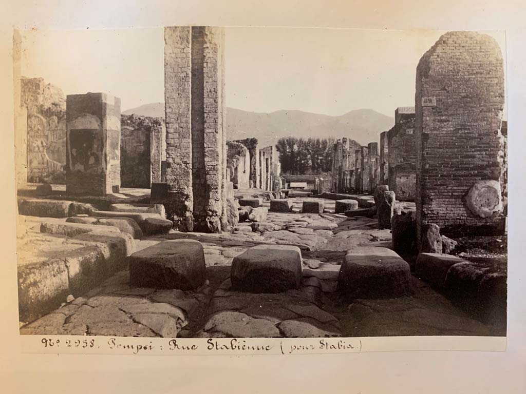 Via Stabiana, Pompeii. 
From an album of Michele Amodio dated 1874, entitled “Pompei, destroyed on 23 November 79, discovered in 1745”. 
Looking south across junction with Via dell’Abbondanza, at Holconius’ crossroads. Photo courtesy of Rick Bauer.
